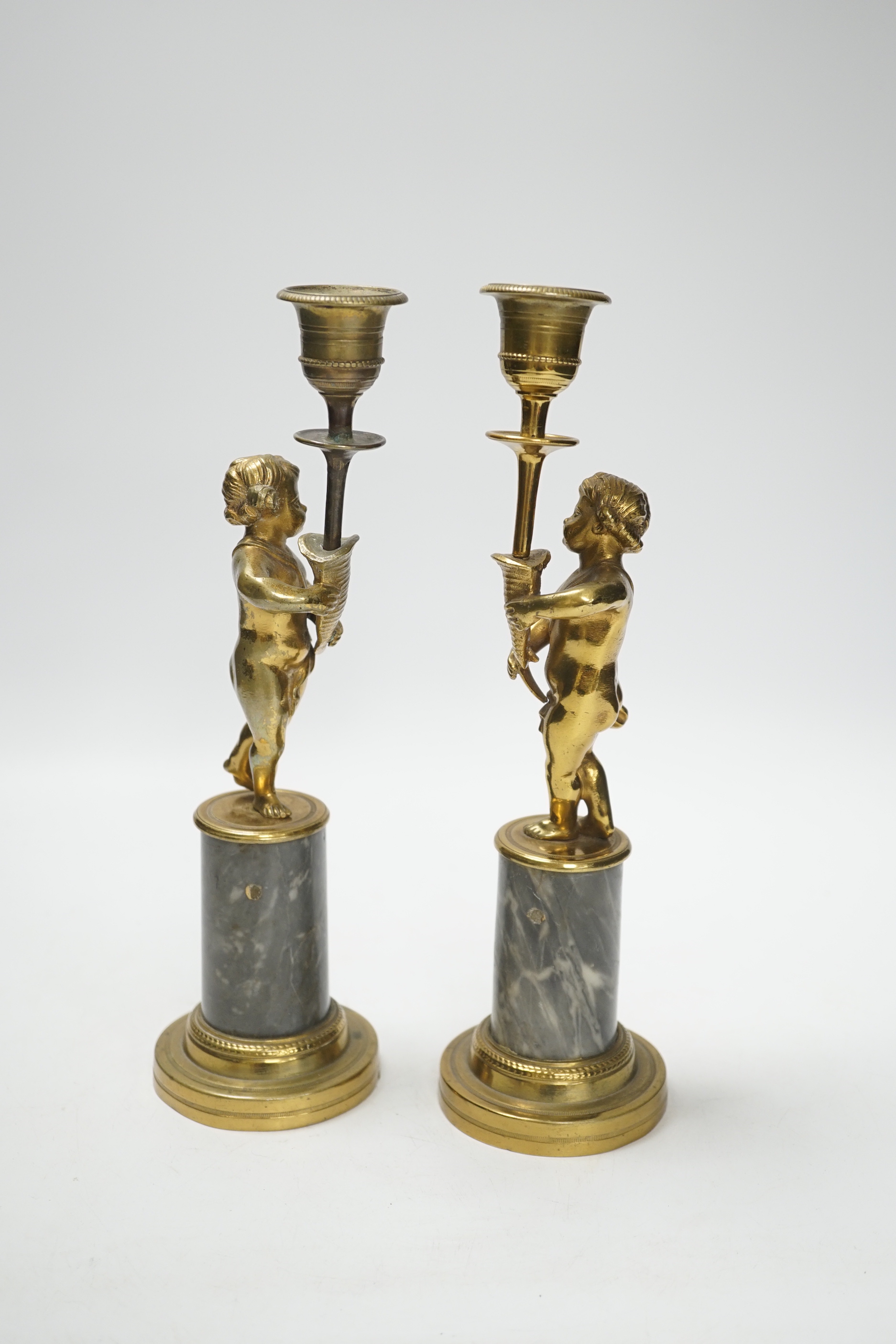 A pair of brass figural and candlesticks, 27cm high